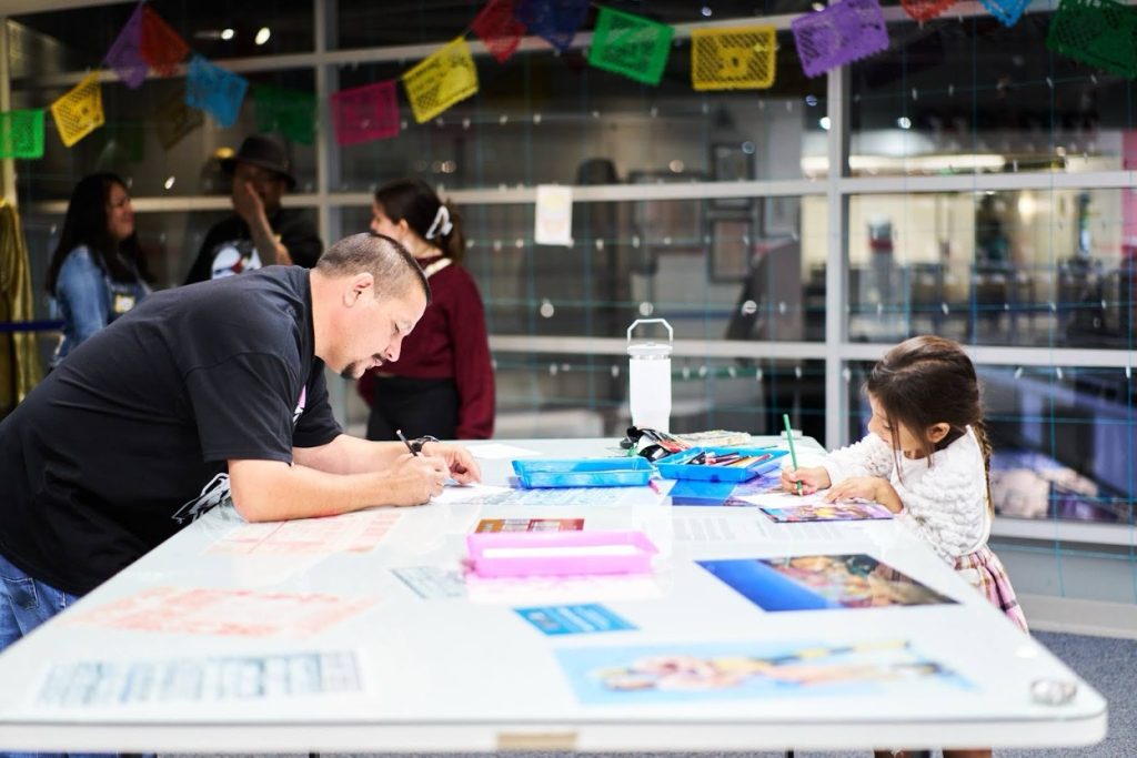 Man and daughter crafting.